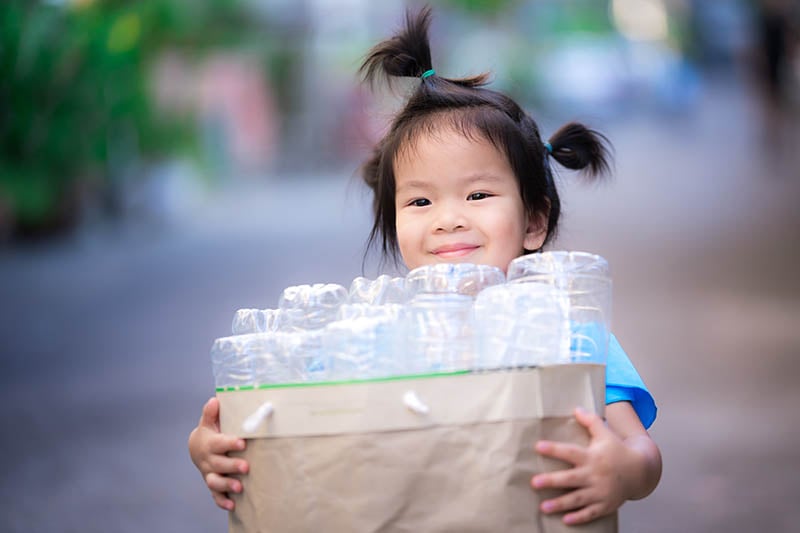 cute-asian-girl-carries-paper-bag-full-of-plastic-cause-early-puberty-2022-11-16-06-38-50-utc